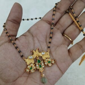 Jadau peacock pendant with black diamonds