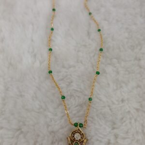 Green manulu with pendant
