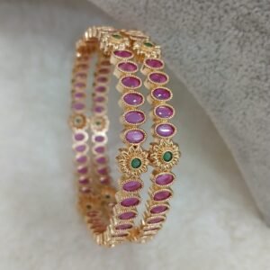 Oval ruby with small green stone flowers